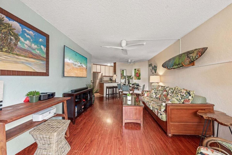 Bright living area featuring Smart TV, ceiling fan, and cozy seating.