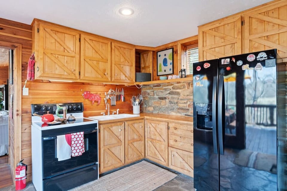 Full kitchen off the living room, fully-stocked with every cooking utensil & all the dish ware you might need.