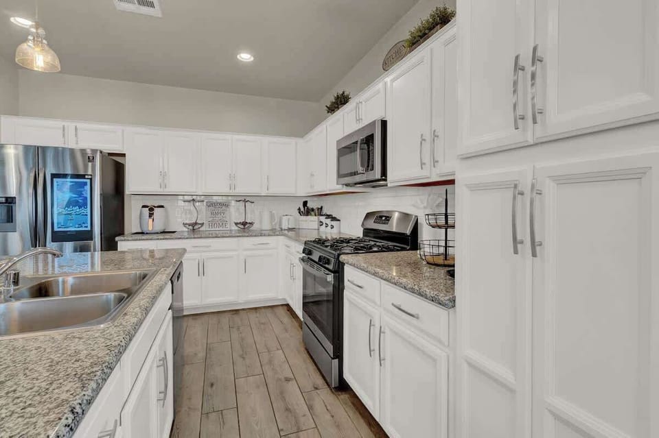 Fully stocked kitchen with complete set of cookware.