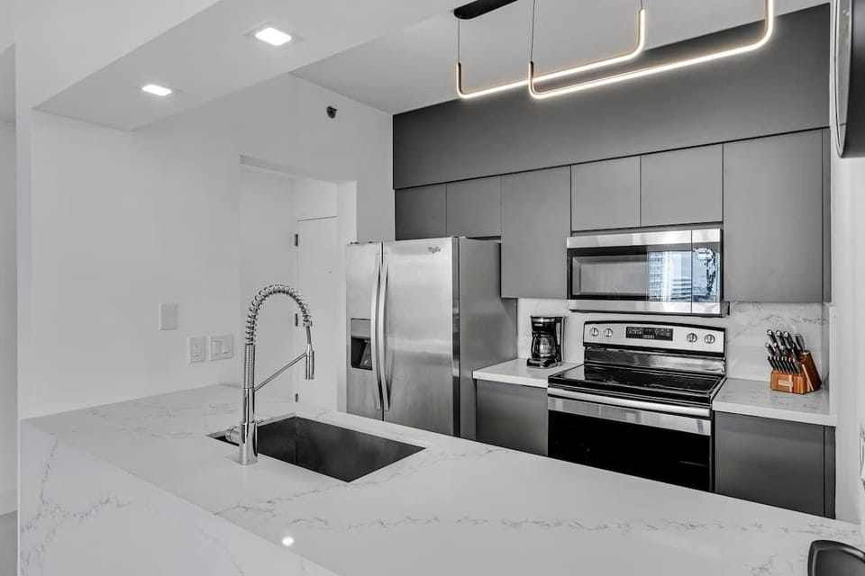 Fully stocked kitchen with complete set of cookware.