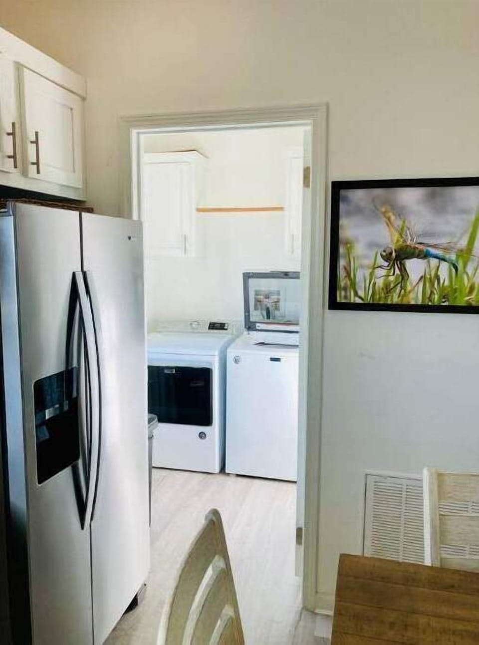 Roomy laundry room in the house with full-size washer and dryer. 