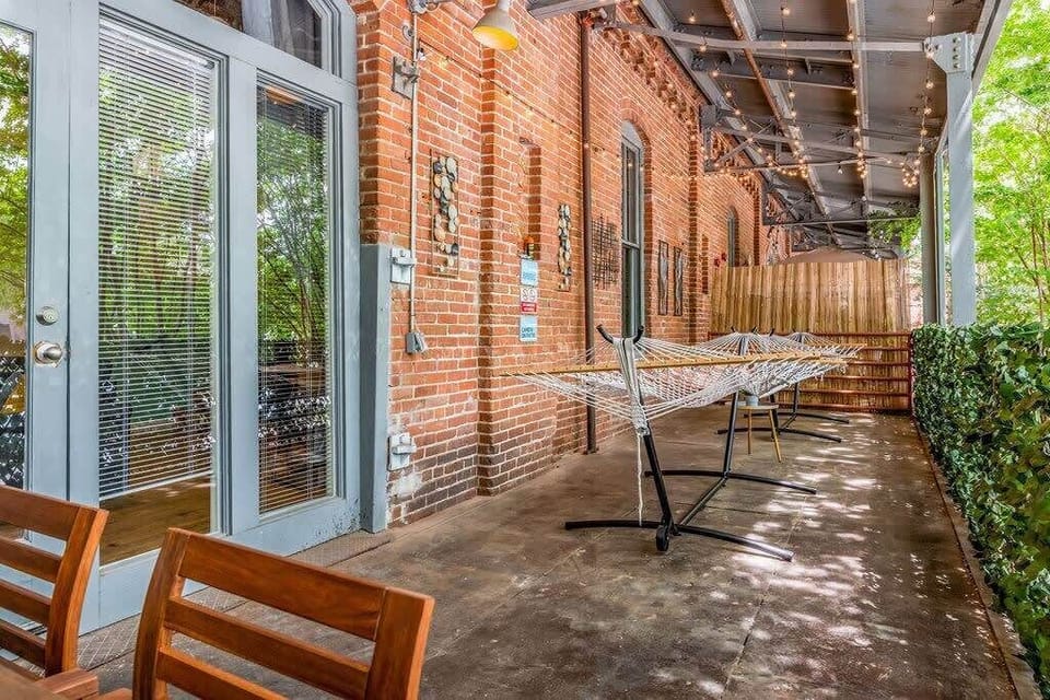36 foot large private balcony with dining table, 2 hammocks, & string lights