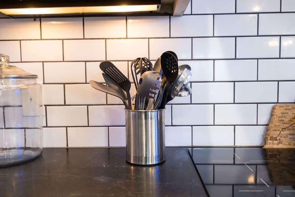 2nd Floor: Fully-equipped kitchen with stainless steel appliances, basic cooking essentials, a large island with bar seating, and wet bar.