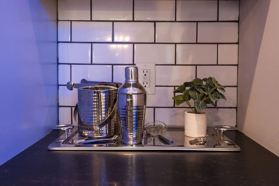 2nd Floor: Fully-equipped kitchen with stainless steel appliances, basic cooking essentials, a large island with bar seating, and wet bar.