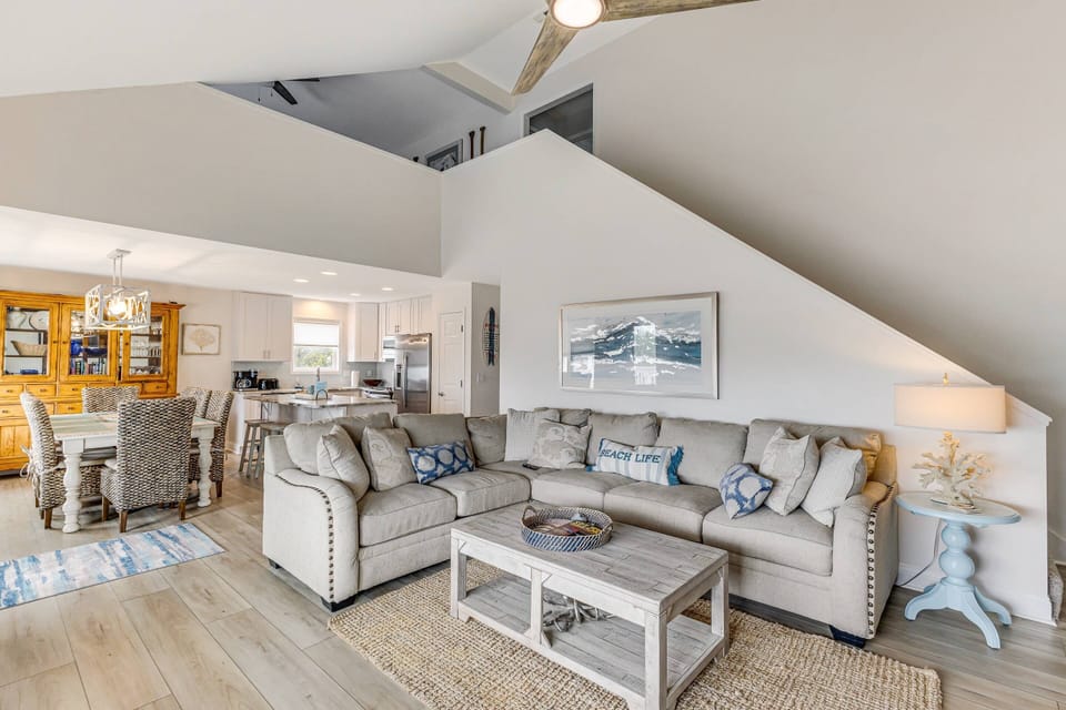 The white cathedral ceilings bring brightness to this space creating a fresh, airy look. The stairs lead to the loft & bedrooms 3 & 4.