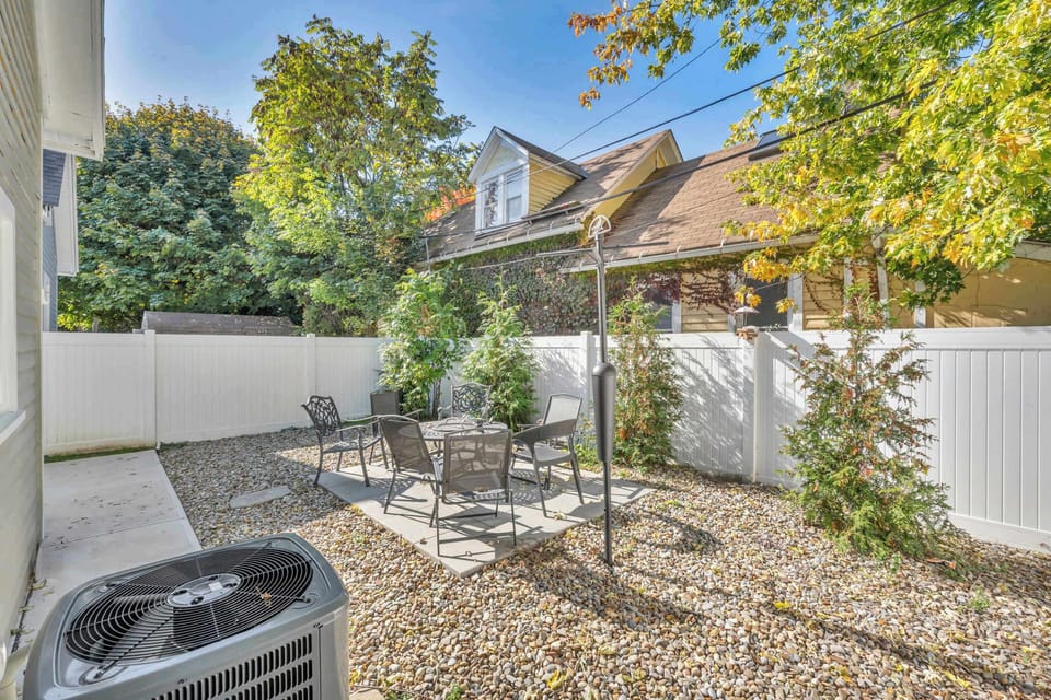 A perfect spot to breathe in the fresh air, this backyard offers comfortable seating and a peaceful ambiance for a relaxing stay.