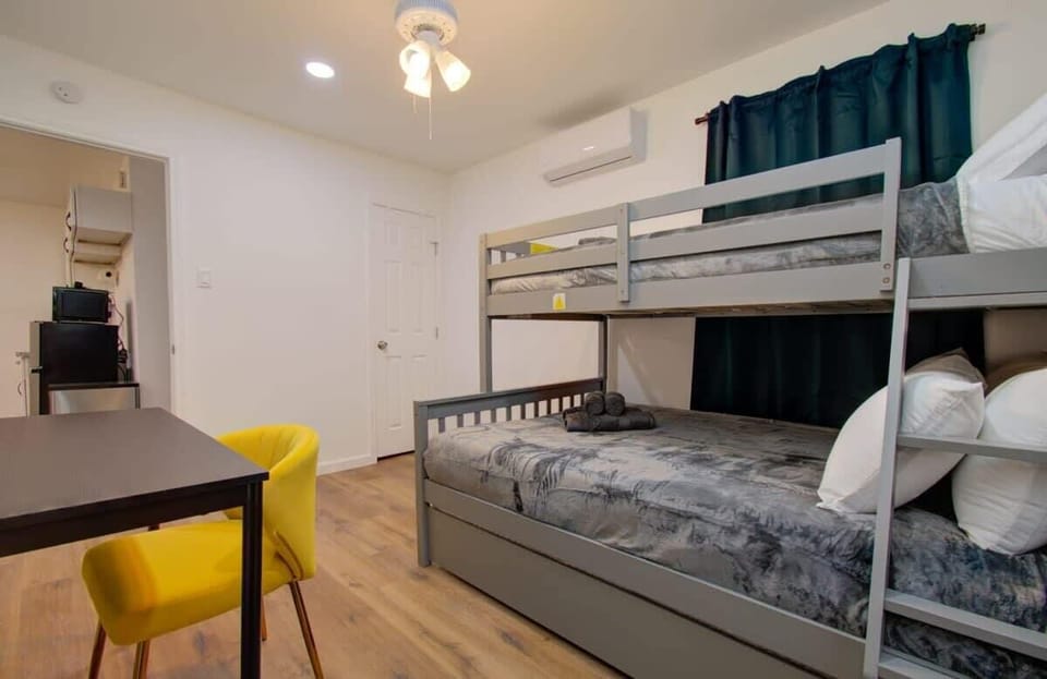 Not only does this bedroom’s bunk bed offer additional sleeping space, but there’s also a workstation for those needing a space to catch up on work or studies.