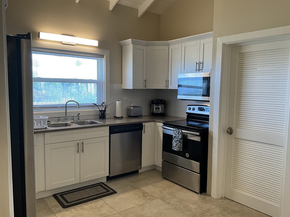 View of the kitchen with door leading to the laundry facility. 