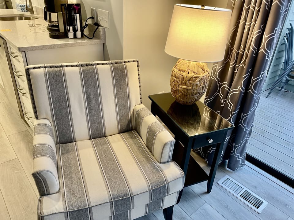 Second accent chair in a reading area.
