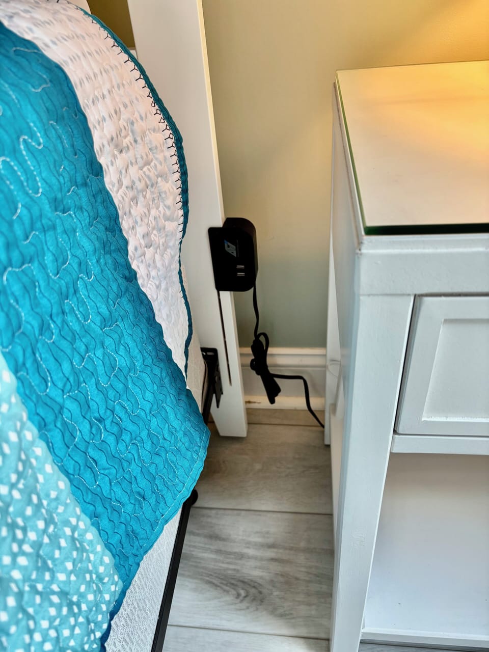 Phone charger on the side of the Master bed.