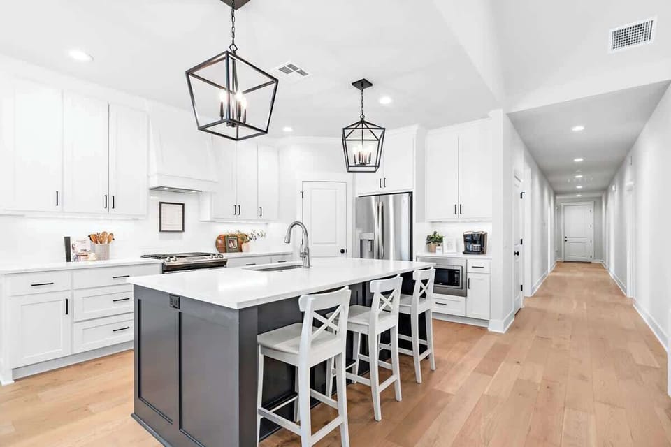 The White Retreat kitchen is open concept with island dining and lots of counter space.