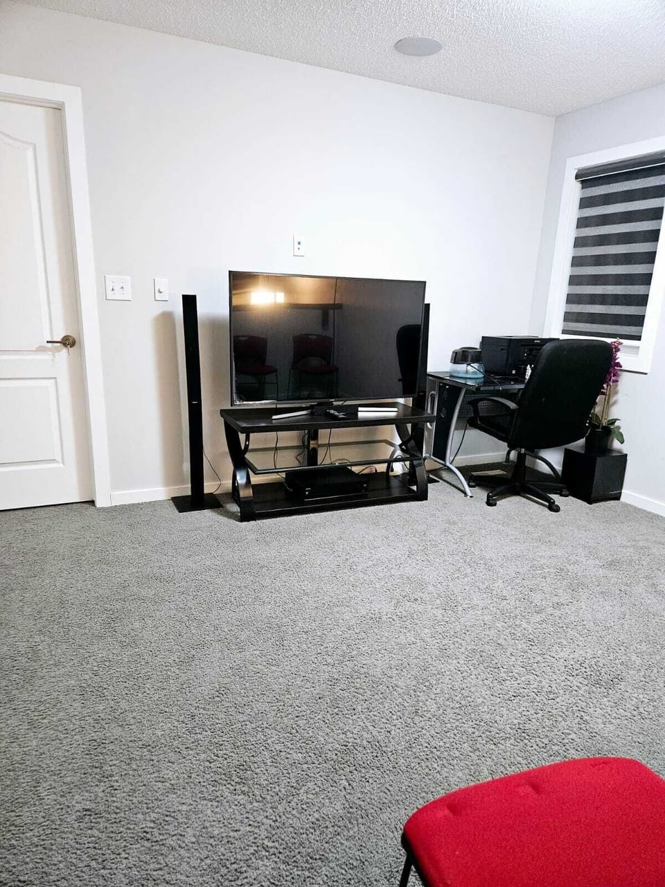 Upstairs living room furnished with 65 inch Samsung TV, sofa bed & office space