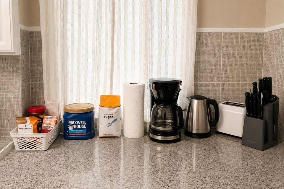 Kitchen comes stocked with a coffee maker, electric kettle, toaster, and a full knife set