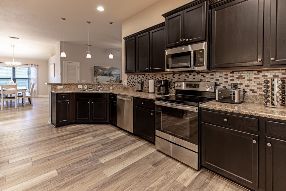 Kitchen Area with stainless steel appliance and fully stocked kitchen 