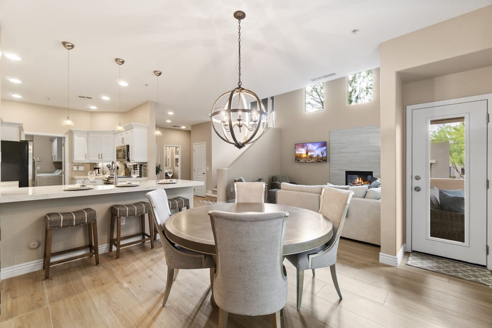 Breakfast bar, dining, living room area with door to relaxing covered patio