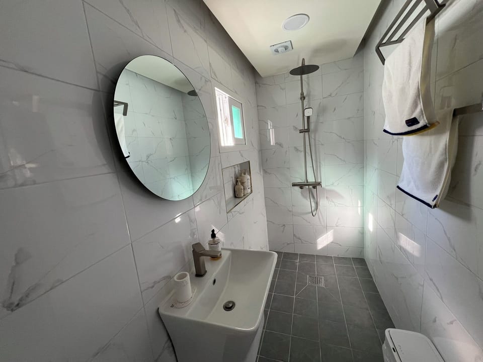 Bright, hotel-style bathroom with premium amenities