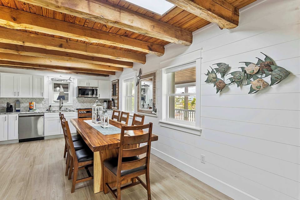Casual dining space near the kitchen w/ natural light & coastal accents.