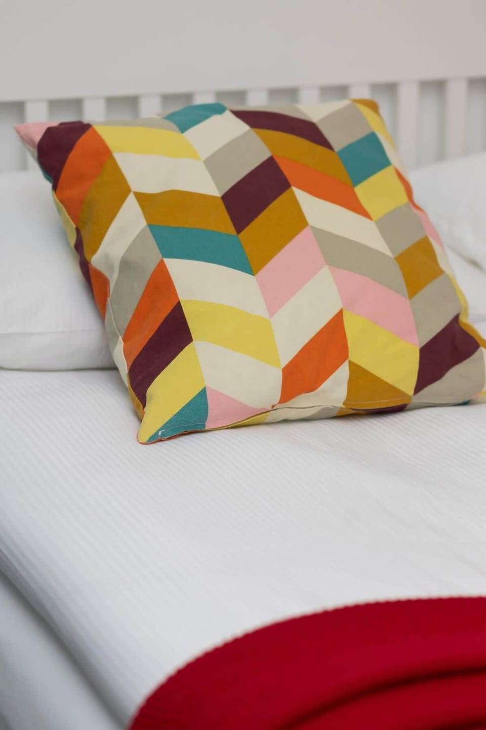 A close-up of a decorative pillow, adding a touch of color to the space.