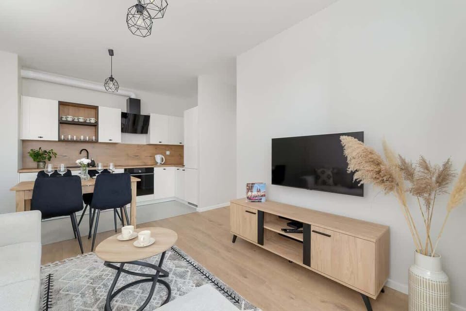 A bright living room with a cozy sofa, a coffee table, and a large window.