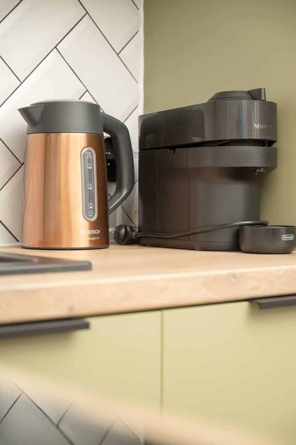 A minimalist kitchen countertop with a stylish electric kettle, matching the modern kitchen design.
