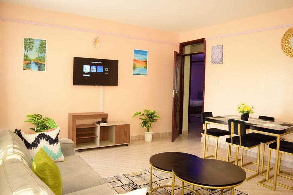 Business Apartment | Living area | 24-inch Smart TV with satellite channels