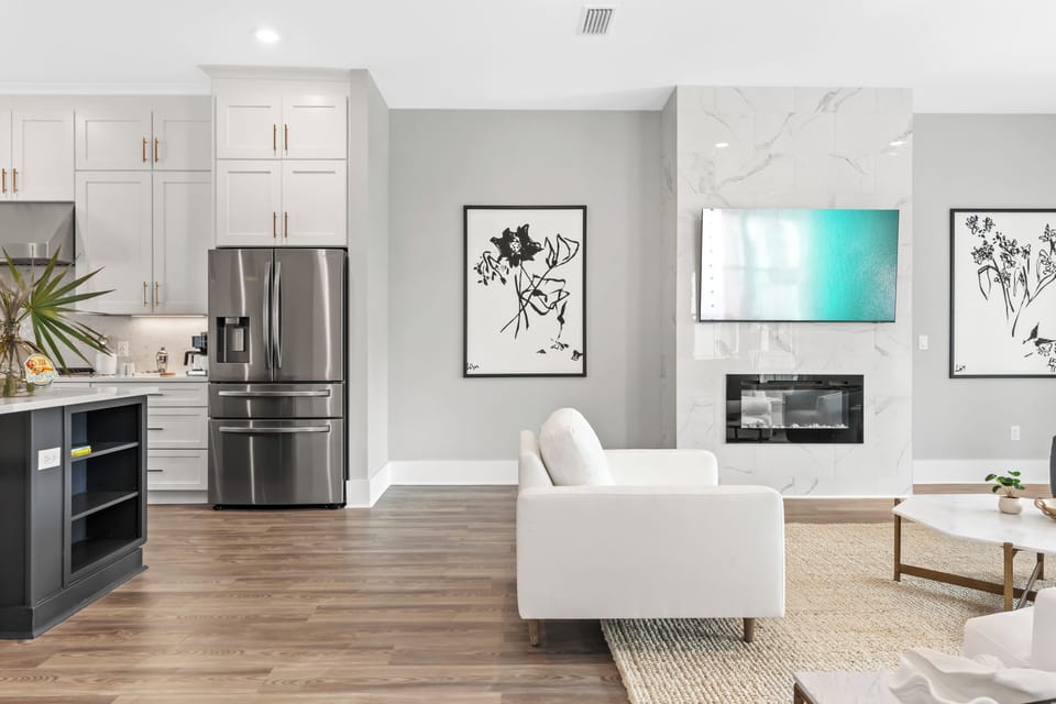 Bright open-concept living with sleek kitchen, modern fireplace, and effortless flow for gathering and relaxing.