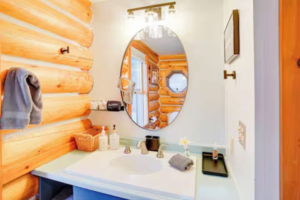 Bright Log Side bathroom with shower and amenities.
(Log Side Bathroom)