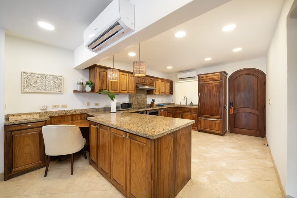 Stylish kitchen with ample space and exquisite wood furnishings, blending functionality with an elegant design