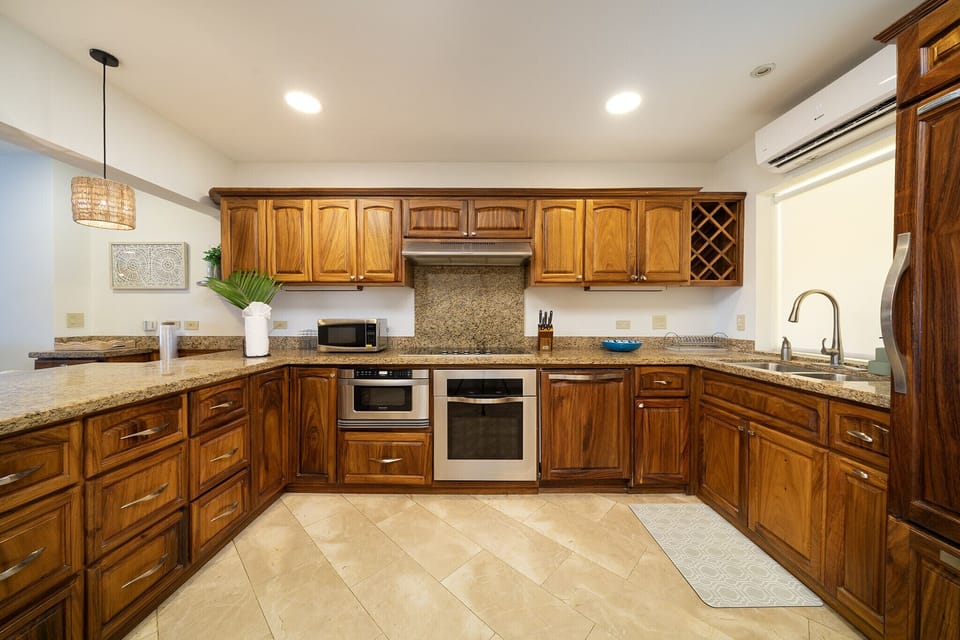 Stylish kitchen with ample space and exquisite wood furnishings, blending functionality with an elegant design