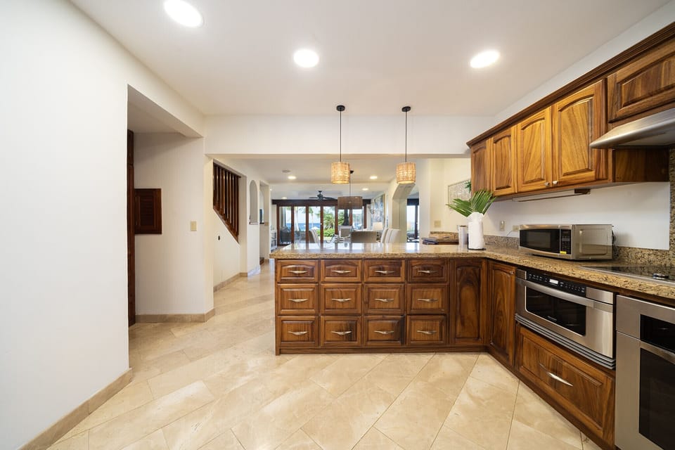 Stylish kitchen with ample space and exquisite wood furnishings, blending functionality with an elegant design