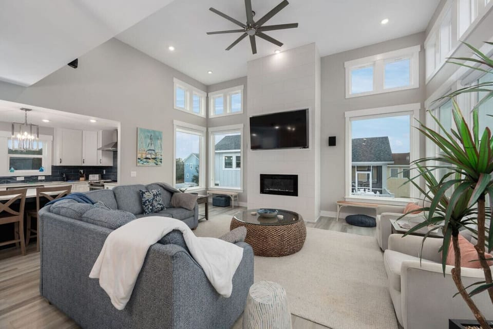 Open living area w/ plush seating, large windows & an airy, welcoming layout.