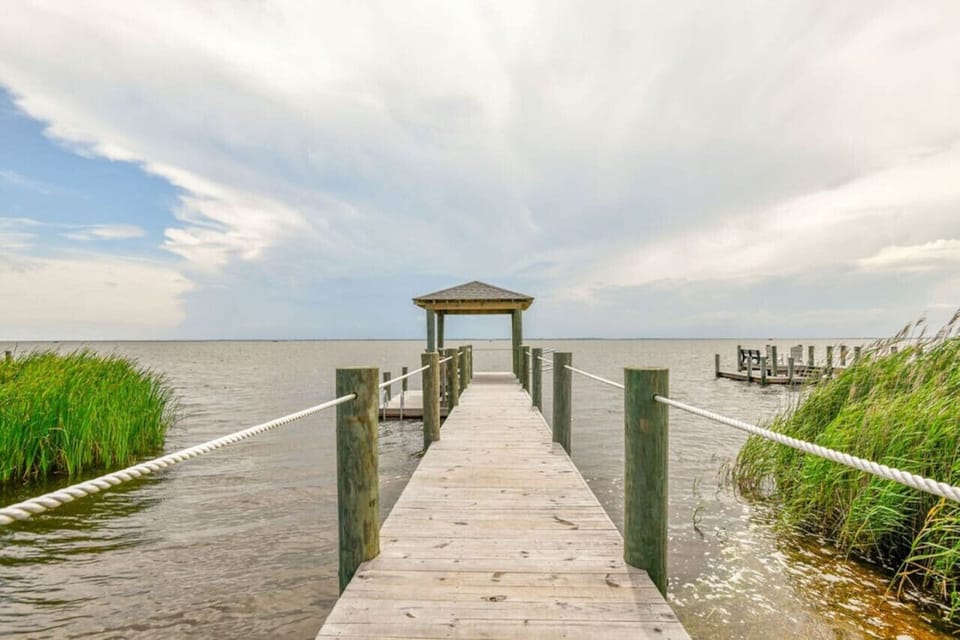 Straight wooden boardwalk leading through dunes toward the shoreline for easy beach access.
