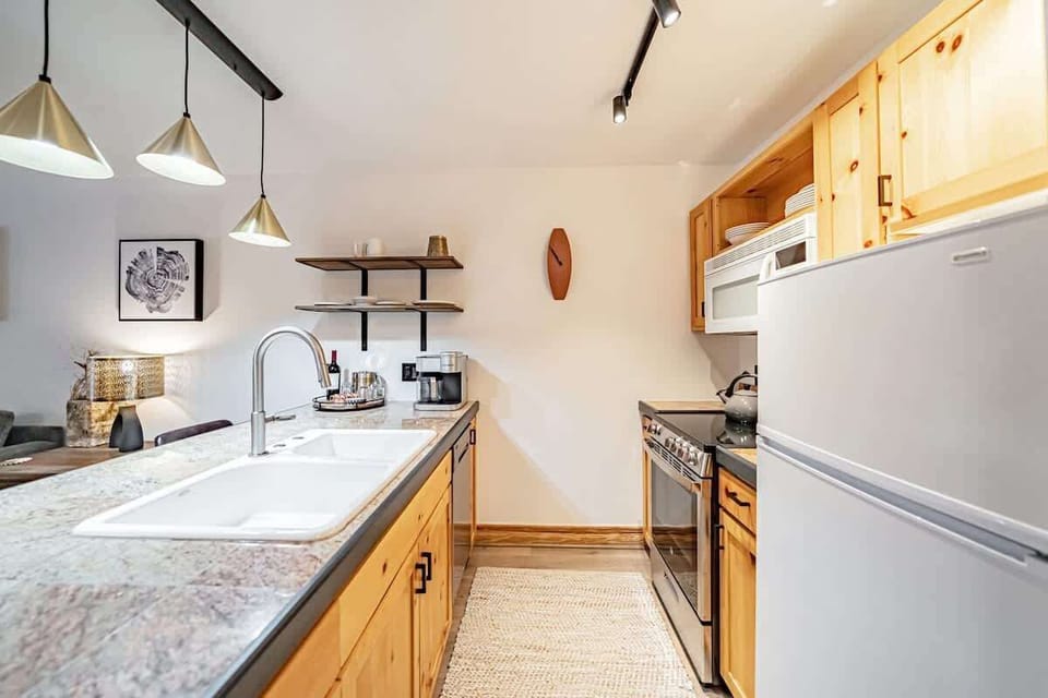 The smaller kitchen is incredibly functional and updated with new appliances.