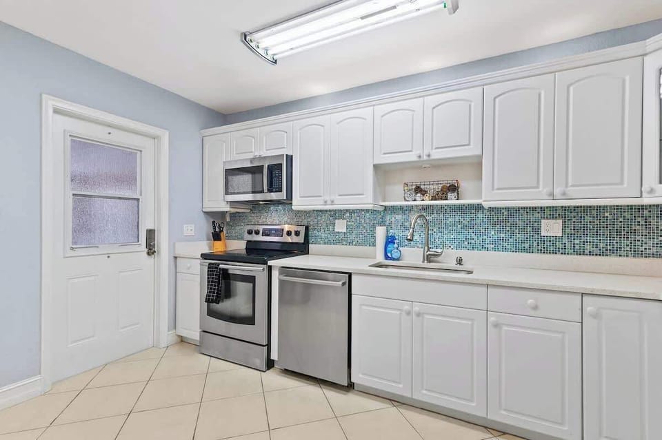 Bright kitchen space with ample cabinet storage.
