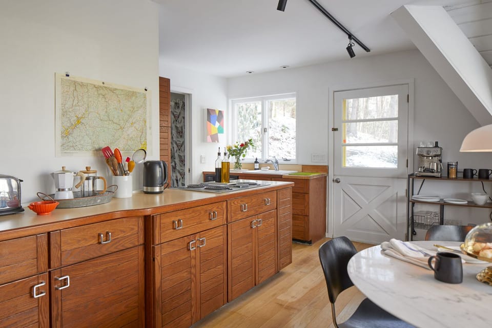 Original 1970's kitchen w/ custom built cabinetry & barn door.