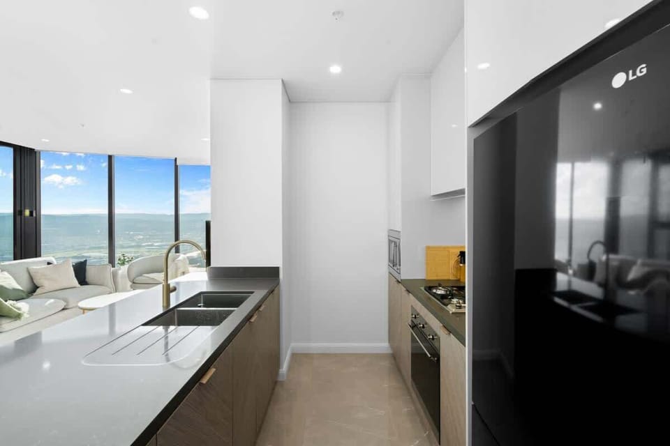 The modern kitchen, boasting premium SMEG stainless-steel appliances, ensures convenience and functionality.