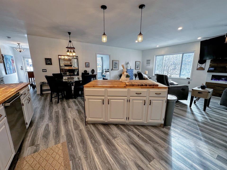 Modern, open-concept kitchen, dining and living area.