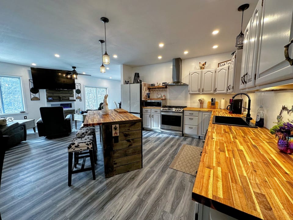Kitchen with new appliances, butcher block counter breakfast bar