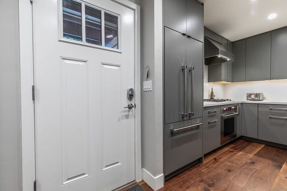 The sleek kitchen greets you as you walk through the front door.