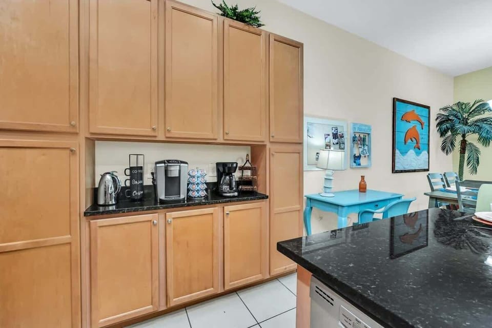 Kitchen area with ample wooden cabinetry and coffee station appliances