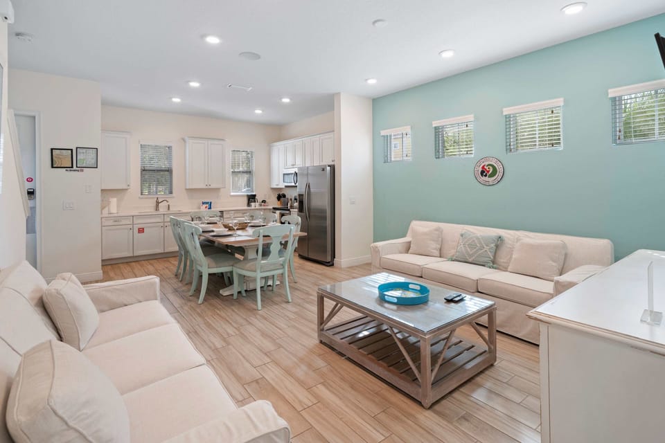 - Alluring living area of the townhouse in Kissimmee Florida - Pastel warm color living area exudes a cozy and inviting atmosphere. - Hues of soft pastels dominating the space - It creates a soothing ambiance that promotes relaxation and serenity