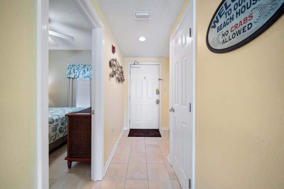 Hallway looking at entrance to unit and guest bedroom on the left