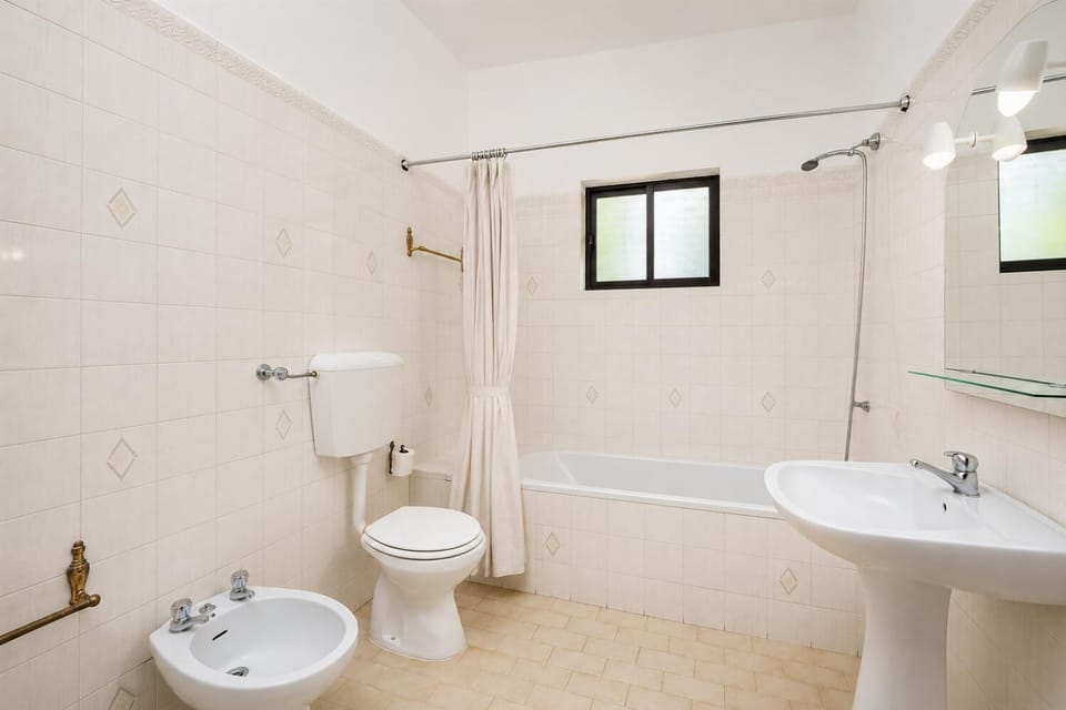 En suite bathroom with bath and shower