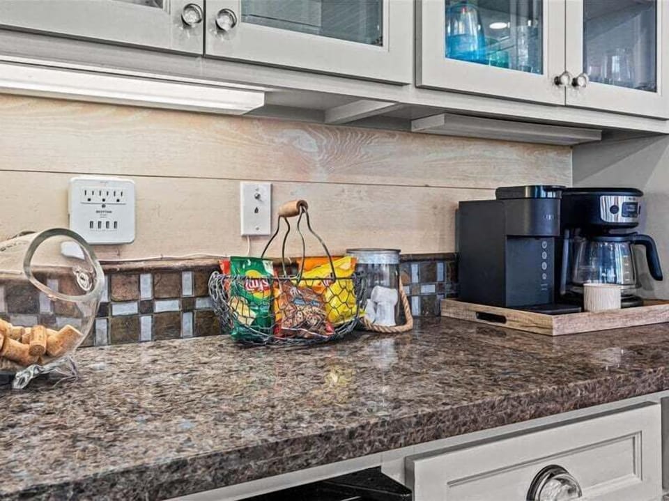 Coffee station with granite countertops and small appliances—perfect morning setup for guests.