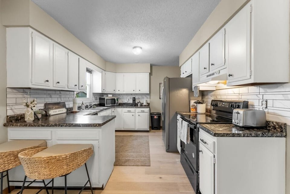 Enjoy morning coffee at the breakfast bar in our bright kitchen.