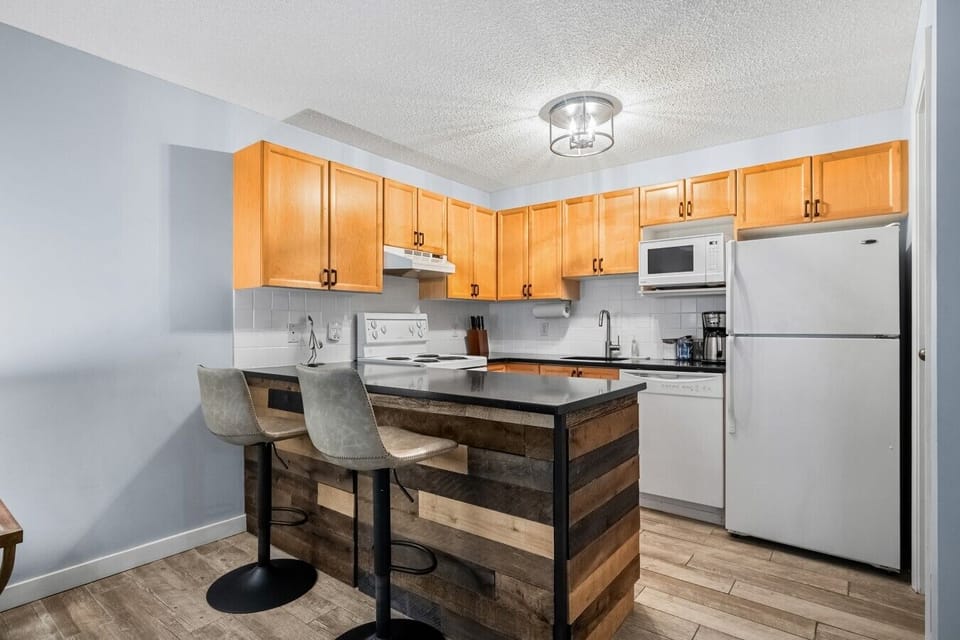 Full kitchen with a blender, crockpot/slow cooker, drip coffee machine, ground coffee, tea, sugar, and basic condiments (ketchup, mustard, relish.)