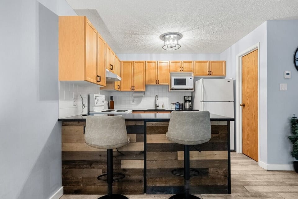 Full kitchen with a blender, crockpot/slow cooker, drip coffee machine, ground coffee, tea, sugar, and basic condiments (ketchup, mustard, relish.)