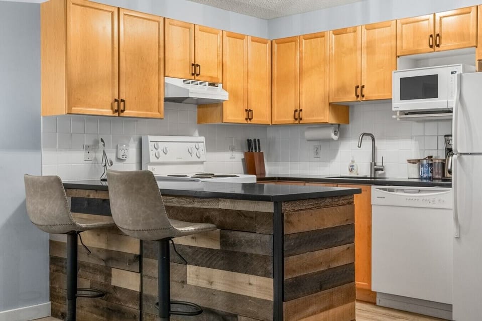 Full kitchen with a blender, crockpot/slow cooker, drip coffee machine, ground coffee, tea, sugar, and basic condiments (ketchup, mustard, relish.)