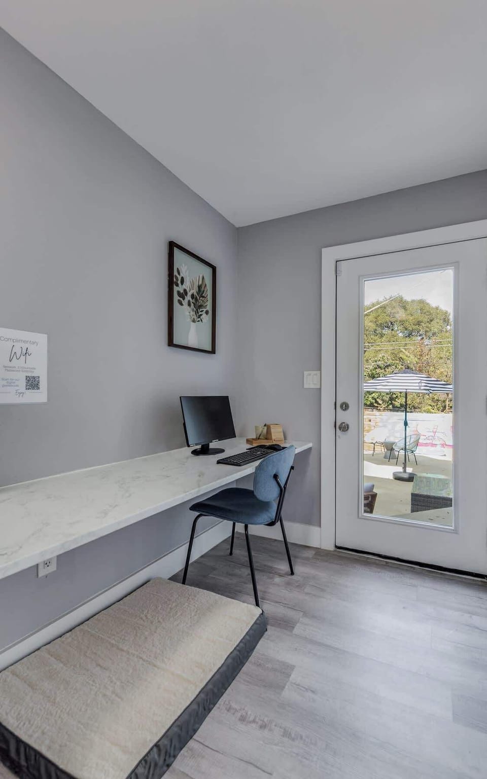 Office area with monitor and keyboard/mouse. Cozy doggie bed!