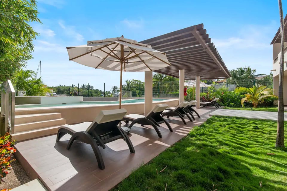 Dive into leisure at our pool oasis with lounge chairs and umbrellas.